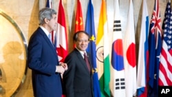 Secretary of State John Kerry, left, walks with Secretary-General of Association of Southeast Asian Nations (ASEAN), Le Luong Minh to their meeting on Sunday, Feb. 16, 2014.