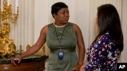 FILE - White House Social Secretary Deesha Dyer, left, talks with a colleague during the annual Mother’s Day Tea hosted by first lady Michelle Obama and Jill Biden to honor military-connected mothers at the White House in Washington, May 8, 2015. 