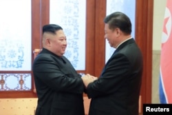 FILE - North Korean leader Kim Jong Un meets President Xi Jinping in Beijing, China, in this photo released by North Korea's Korean Central News Agency (KCNA).
