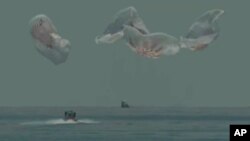 In this frame grab from NASA TV, the SpaceX capsule splashes down Sunday, Aug. 2, 2020 in the Gulf of Mexico. (NASA TV via AP)