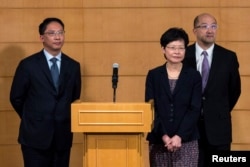 Hong Kong's Secretary for Justice Rimsky Yuen (L-R), Chief Secretary for Administration Carrie Lam, Secretary for Constitutional and Mainland Affairs Raymond Tam attend a news conference after meeting with the Hong Kong Federation of Students (HKFS).