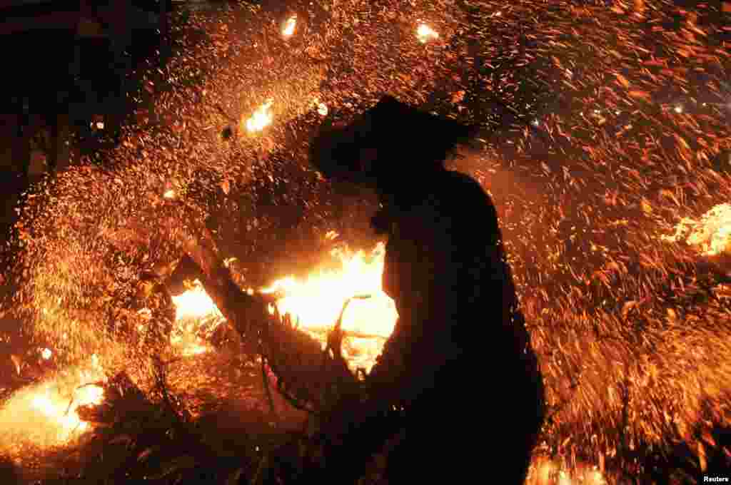 A participant is seen during the torch war or &quot;Perang Obor,&quot; a tradition held by locals to show gratitude to God for fortune, health, and salvation, in Jepara, Central Java province, Aug. 5, 2019, in this photo taken by Antara Foto.