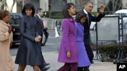 President Barack Obama, waves as he walks with his daughters Sasha and Malia, first lady Michelle Obama and mother-in-law Marian Robinson to St. John's Church in Washington, January 21, 2013, for a church service during the 57th Presidential Inauguration. 