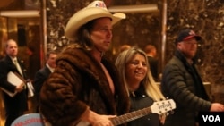 Seemingly a Trump Tower staple, the "naked cowboy" gets a lot of attention from tourists, but is mostly ignored by the press at Trump Tower in New York, Dec. 12, 2016. (R. Taylor/VOA)