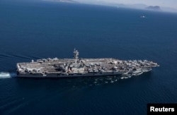 FILE - The Nimitz-class aircraft carrier USS Abraham Lincoln transits the Strait of Gibraltar, entering the Mediterranean Sea as it continues operations in the 6th Fleet area of responsibility, April 13, 2019.