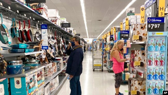 FILE - Consumers shop at a Walmart store in Vernon Hills, Ill., May 23, 2021.