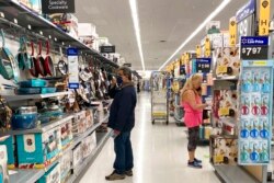 FILE - Consumers shop at a Walmart store in Vernon Hills, Ill., May 23, 2021.