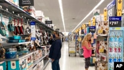 FILE - Consumers shop at a Walmart store in Vernon Hills, Ill., May 23, 2021. 