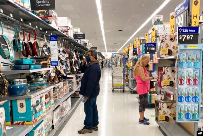 FILE - Consumers shop at a Walmart store in Vernon Hills, Ill., May 23, 2021.