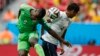 France&#39;s Raphael Varane is hit by the ball in the face beside Nigeria&#39;s Emmanuel Emenike.
