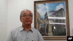 Toshiki Fujimori, an atomic bombing survivor who is a top official at Hidankyo, a Japanese organization for the survivors, stands in front of a painting of the Atomic Bomb Dome in Hiroshima, Japan, Aug, 5, 2017, ahead of the 72nd anniversary of the first atomic bombing.