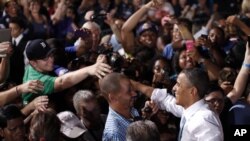 President Barack Obama greets supporters at a campaign event in Desert Pines High School in Las Vegas, Nevada, Sept. 30, 2012. 