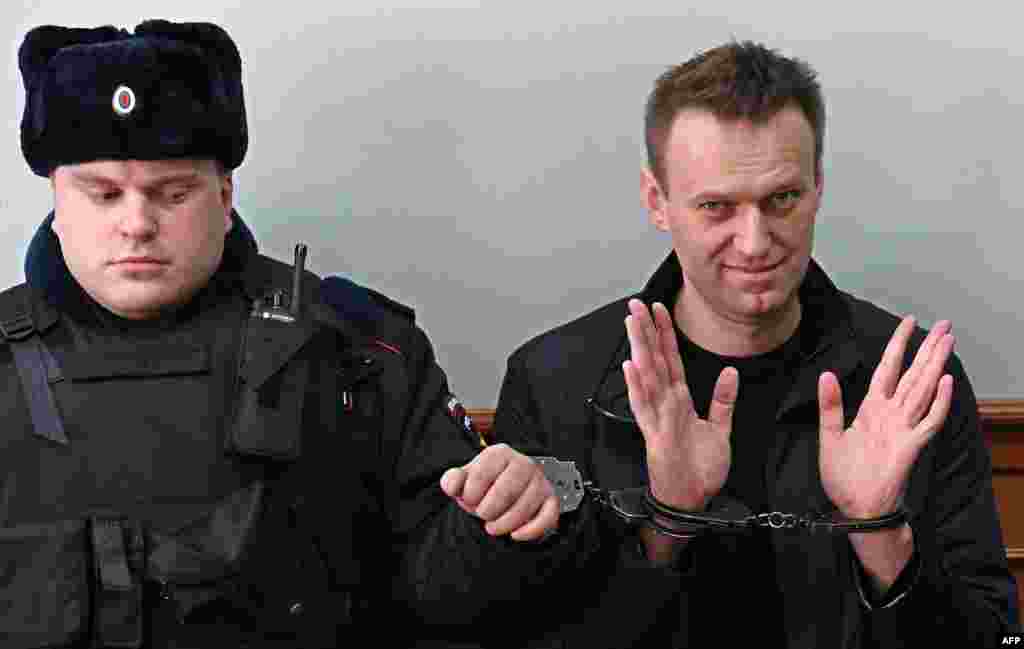 Kremlin critic Alexei Navalny, who was arrested during March 26 anti-corruption rally, gestures during an appeal hearing at a court in Moscow, Russia.