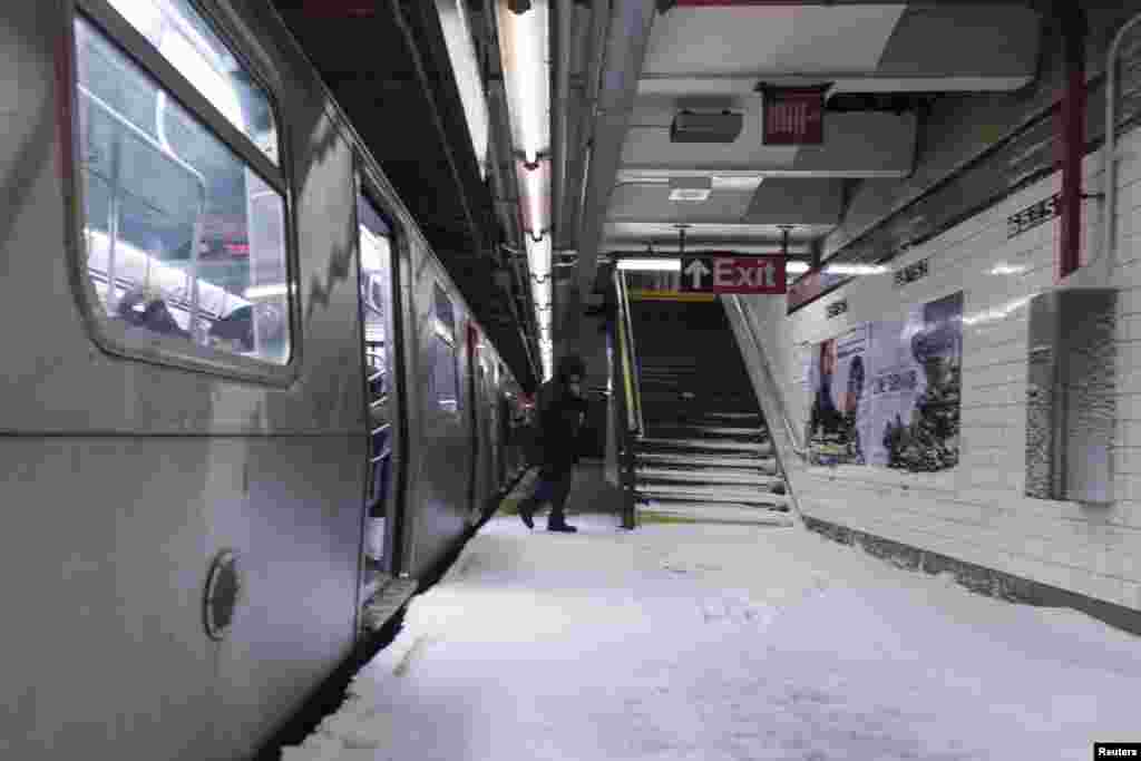 Snow makes it way down to the platform of the 65th Street subway station in New York, Jan. 3, 2014. 
