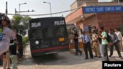 A police vehicle carrying four men accused of the gang rape of a 23-year-old woman on a bus on December 16, enters a court in New Delhi, September 10, 2013. 