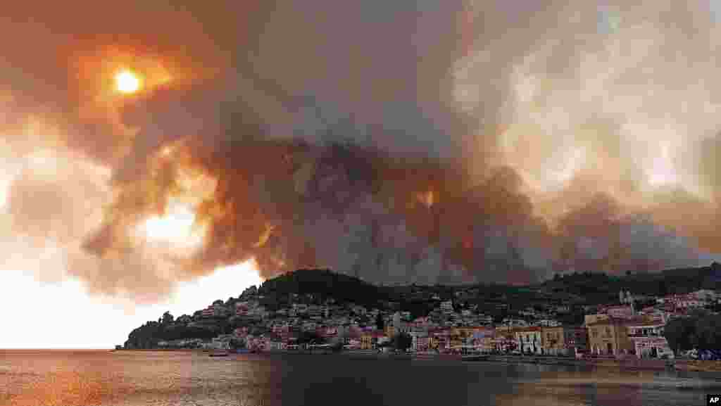 Flames burn on the mountain near Limni village on the island of Evia, about 160 kilometers (100 miles) north of Athens, Greece.