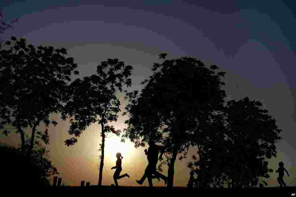 An Egyptian family spends time at Al-Azhar Park, one of the city's few public parks as the sun sets in Cairo, Egypt.