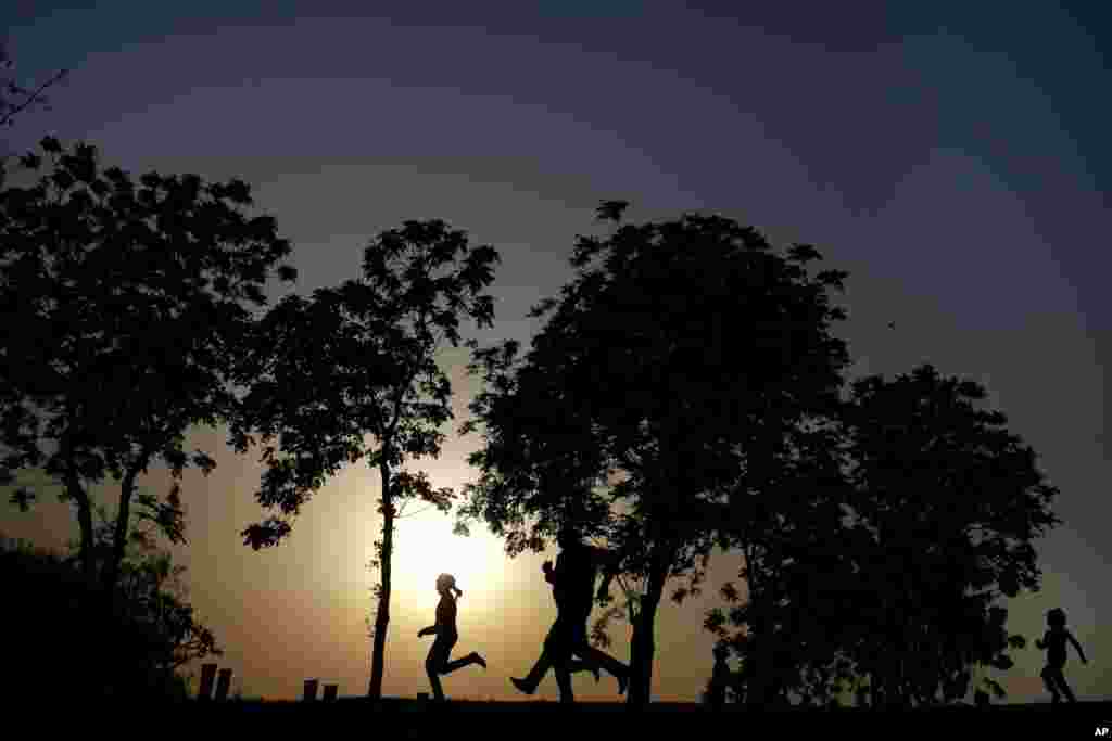 An Egyptian family spends time at Al-Azhar Park, one of the city&#39;s few public parks as the sun sets in Cairo, Egypt.