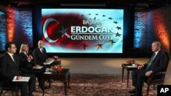 FILE - Turkey's President Recep Tayyip Erdogan, right, is seen during an interview with A Haber and ATV television channels, in Istanbul, Dec. 15, 2019.