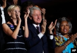 Former President Bill Clinton applauds Former Democratic Presidential candidate, Sen. Bernie Sanders, I-Vt., as he speaks during the first day of the Democratic National Convention in Philadelphia , Monday, July 25, 2016.