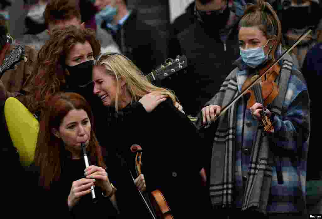 A musician reacts during the funeral of late 23-year-old teacher, Ashling Murphy, who was murdered while out jogging, outside the St. Brigid&#39;s Church in Mountbolus near Tullamore, Ireland.