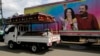 A truck carrying coffins goes past a banner of Nicaragua's President -- and presidential candidate -- Daniel Ortega and his wife and running mate, Rosario Murillo, on a mobile clinic, in Masaya on Nov. 2, 2021.