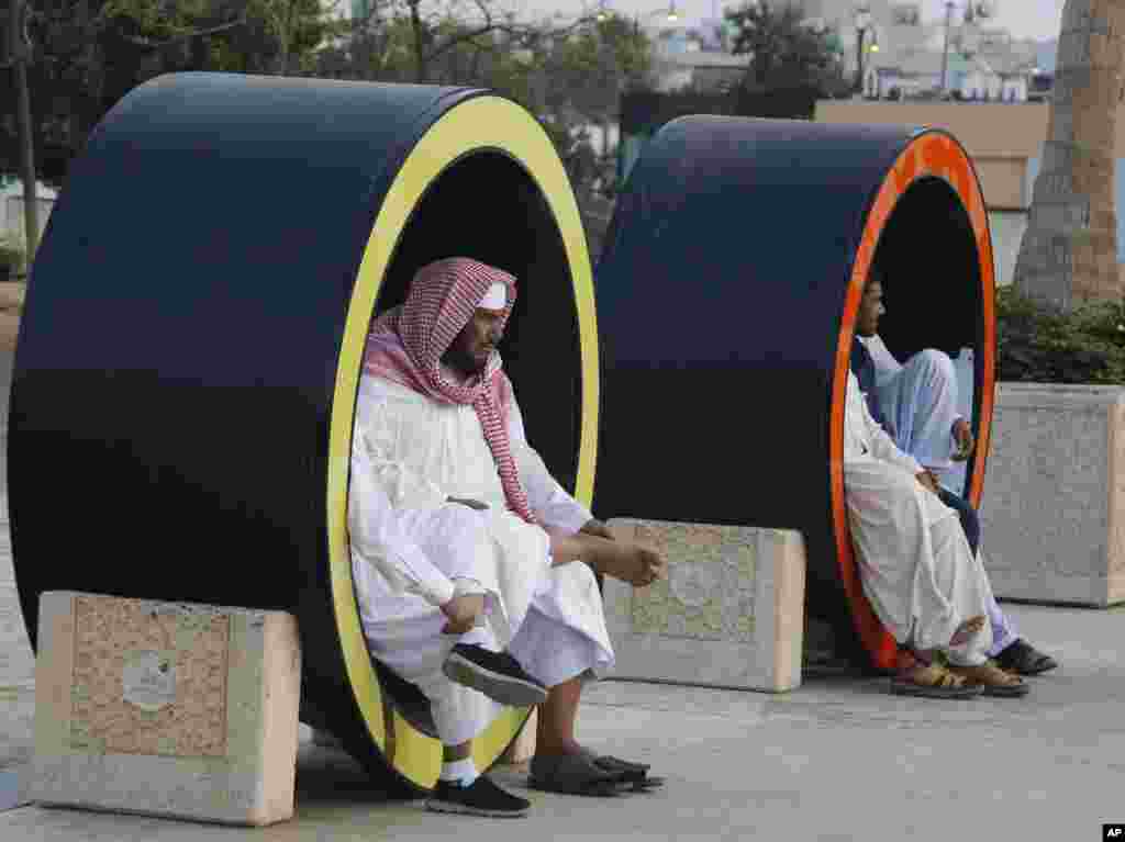 Saudis sit as they visit the Red Sea beach, in Jiddah, Saudi Arabia.