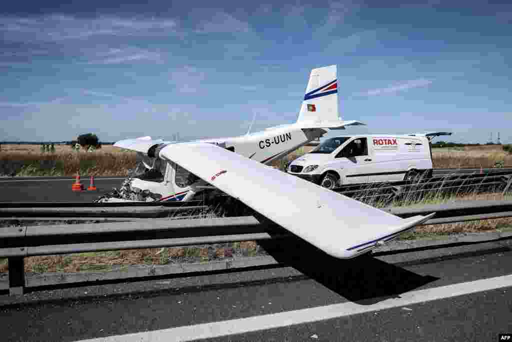 Wreckage of a small plane is pictured after crashing on a highway close to Pinhal Novo, Portugal.
