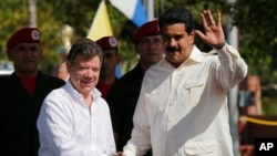 哥倫比亞總統桑托斯（左）本月早些時候在與委內瑞拉總統馬杜羅（右）會面。