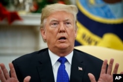 FILE - President Donald Trump speaks during a meeting with Democratic leaders in the Oval Office in Washington, Dec. 11, 2018.