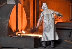 A worker controls iron at the Thyssenkrupp steel factory in Duisburg, Germany, April 27, 2018.