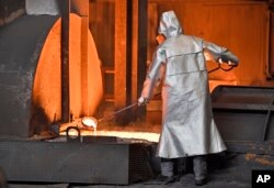 A worker controls iron at the Thyssenkrupp steel factory in Duisburg, Germany, April 27, 2018.
