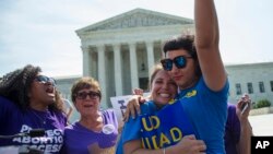 FILE - Bethany Van Kampen, left, hugs Alejandra Pablus as they celebrate during a rally at the Supreme Court in Washington, June 27, 2016, after the court struck down Texas' widely replicated regulation of abortion clinics.