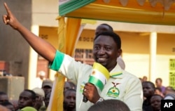 FILE - Presidential candidate Frank Habineza of the opposition Democratic Green Party gestures to supporters at an election campaign rally in Musanze District, Rwanda, July 28, 2017.