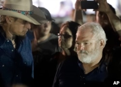 Stephen Willeford, right, and Johnnie Langendorff, left, attend a vigil for the victims of the First Baptist Church shooting in Sutherland Springs, Texas, Nov. 6, 2017. Willeford shot suspect Devin Patrick Kelley, and Langendorff drove the truck while chasing Kelley. Kelley had opened fire inside the church in the small South Texas community on Sunday.