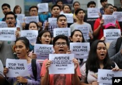 FILE - Filipino student activists shout slogans as they call for justice for victims of extrajudicial killings during a rally at the University of the Philippines in suburban Quezon city, north of Manila, Philippines, Aug. 11, 2016.