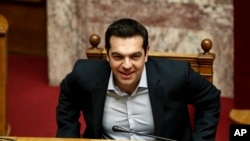 Greece's Prime Minister Alexis Tsipras takes his seat to attend a parliamentary session ahead of a vote, in Athens, Dec. 15, 2015.