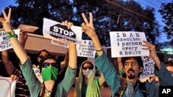 Thousands of defiant Iranian opposition supporters have staged what they said was a rally supporting Arab revolts as riot police armed with batons moved in to disperse them, February 14, 2011