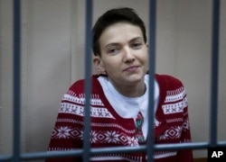 FILE - Ukrainian jailed military officer Nadezhda Savchenko sits in a cage at a court room in Moscow, Russia, March 4, 2015.
