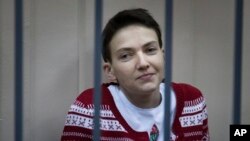 FILE - Ukrainian jailed military officer Nadezhda Savchenko sits in a cage at a court room in Moscow, Russia, March 4, 2015. Savchenko launched a hunger strike on April 6, 2016, to demand her return to Ukraine, according to her lawyer.