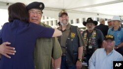 Vietnam veteran Ignacio Perez becomes emotional as Luci Baines Johnson, daughter of president Lyndon B. Johnson, pins a medal on his shirt at the Vietnam War Summit at the LBJ Presidential Library in Austin, Texas on Wednesday, April 27, 2016.