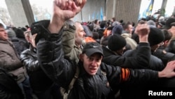 People attend a rally organized mainly by ethnic Russians near the Crimean parliament building in Simferopol, Feb. 26, 2014.