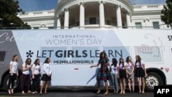 U.S. first lady Michelle Obama poses with young female students in front of the White House before an event to mark International Women's Day, as part of the first lady's Let Girls Learn initiative, in Washington, D.C., March 8, 2016.