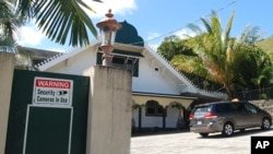 FILE - A security camera warning sign is seen at the Muslim Association of Hawaii in Honolulu, Feb. 9, 2017. Hawaii is planning to challenge President Donald Trump's revised travel ban. A motion filed in federal court March 7, 2017, in Honolulu says the state wants to amend its existing lawsuit challenging Trump's previous order.