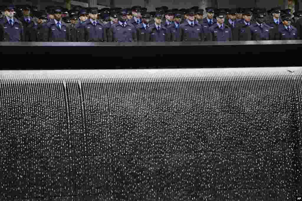 Probationary New York firefighters stand at attention at the Sept. 11 Memorial during a wreath laying ceremony in New York. The FDNY&rsquo;s 300 probationary firefighters participated in the ceremony to honor the fathers of two classmates who were killed in the attacks of Sept. 11, 2001.