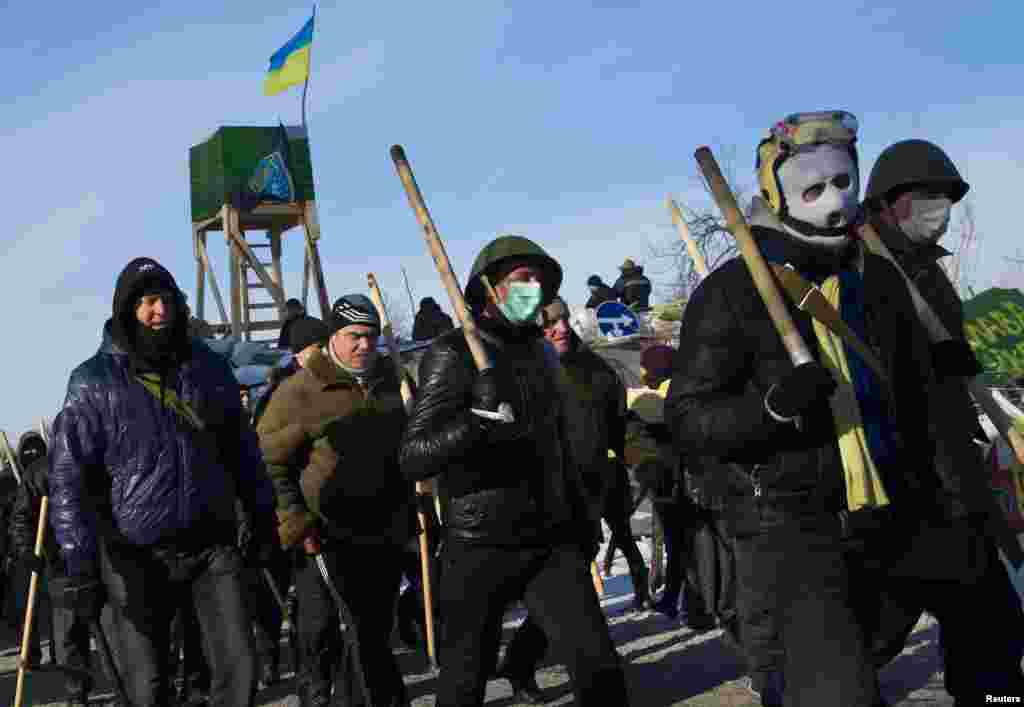 Members of various anti-government paramilitary groups walk in formation during a show of force in Kyiv, Jan. 29, 2014.&nbsp;