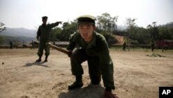 In this photo taken April 17, 2010, recruits of the Kachin Independence Army, one of Myanmar's largest armed ethnic groups, go through battle drills at a training camp near Laiza in Burma.