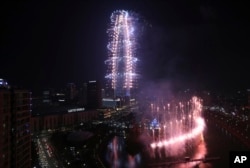 A firework display marks the official opening of the Lotte World Tower building in Seoul, South Korea, Sunday, April 2, 2017.