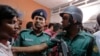 Bangladeshi policemen try to control the crowd of onlookers at a building where two people were found stabbed to death in Dhaka, Bangladesh, April 25, 2016. 