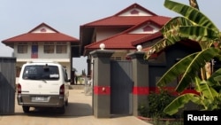 FILE - A van enters a residence that temporarily housed asylum seekers coming from a remote South Pacific detention center, in Phnom Penh, Cambodia. Gen. Tan Sovichea, head of the refugee office in Cambodia's Interior Ministry, said the Iranian couple departed for Iran on February 12.
